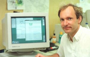 Tim Berners-Lee in front of an early computer
